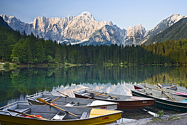 Rowing boats at the banks of Laghi di Fusine, Julian Alps, Italy, Europe