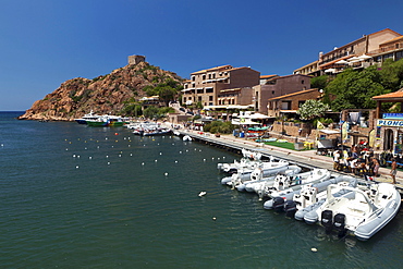 Motor boats in the Porto Harbor with the Genuese Tower in the background, L Ile-Rousse, Corsica, France