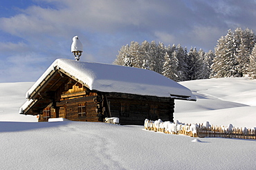 Snow covered alpine hut, Alpe di Siusi, Schlern, South Tyrol, Italy, Europe