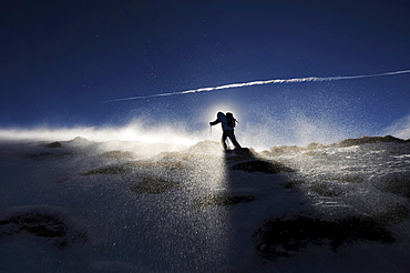 Backlit person snowshoeing, Alto Adige, South Tyrol, Italy, Europe