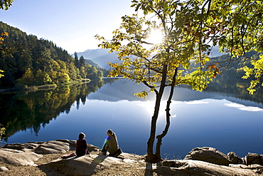 People at the shore of lake Monticolo in autumn, Eppan an der Weinstrasse, Alto Adige, South Tyrol, Italy, Europe