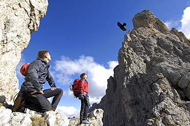 Mountaineers watching a bird of prey, Alto Adige, South Tyrol, Italy, Europe