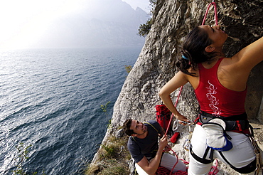 Two climbers at a rock face above lake Garda, Italy, Europe