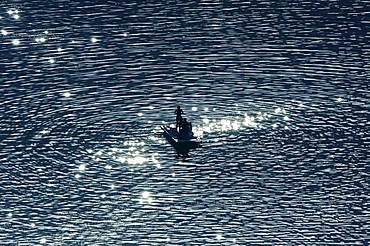 People in a pedal boat on lake Kalterer See, Bolzano, South Tyrol, Alto Adige, Italy, Europe