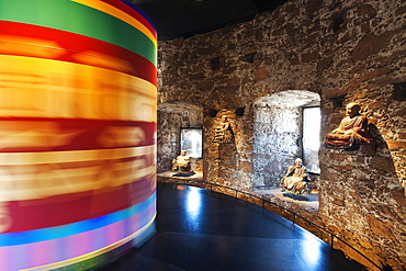 Prayer wheel and Buddha figures at the museum of Sigmundskron castle, Bolzano, South Tyrol, Alto Adige, Italy, Europe