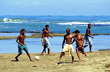 Boys playing football on the beach, Puerto Viejo, Costa Rica, Caribbean, America