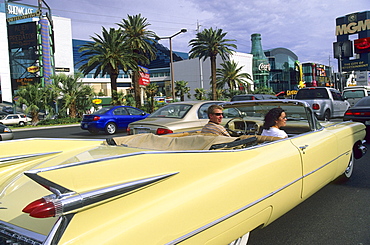 A couple in a Cadillac on Las Vegas Boulevard, Las Vegas, Nevada, USA, America