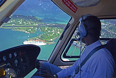 Pilot in helicopter over Castries, St. Lucia, Caribbean, America