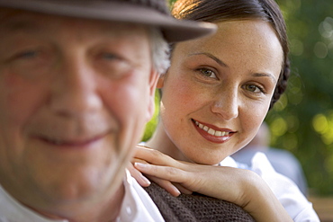 Mature man with young woman in beergarden near Lake Starnberg, Bavaria, Germany