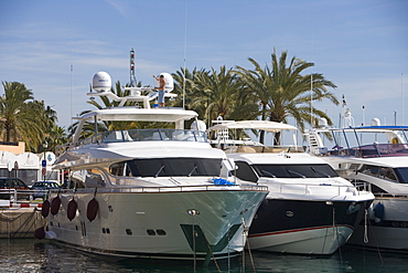 Man Scrubs Deck aboard Luxury Yacht in Puerto Portals Marina, Puerto Portals, Mallorca, Balearic Islands, Spain