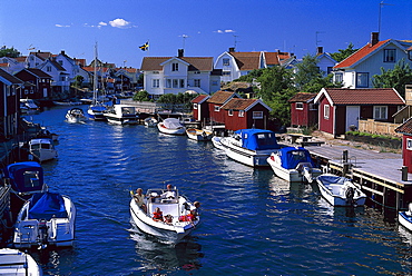 Sound Bohuslaen with boats in a village under blue sky, Sweden, Europe