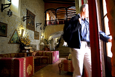 A mature man standing in the parlour of Finca Monnaber Nou, Tramuntura, Majorca, Spain