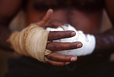 Boxer Little Lizard putting on bandages, getting ready for fight, Fred Brophy's Boxing Troupe, Australia