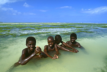 Local boys on the beach, near Paje, East coast of Zanzibar, Tanzania, Africa