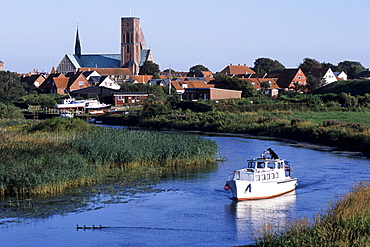 Boat on the Ribe River, Ribe cathedral in the background, Ribe, Southern Jutland, Denmark