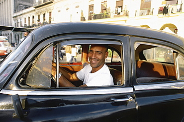 A man looking smiling out of a car, Prado, Havana, Cuba