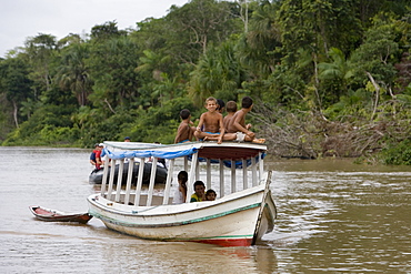 Young Amazon Indian boys on a boat on the Rio do Cajari, a branch of the Amazon River, Para, Brazil, South America