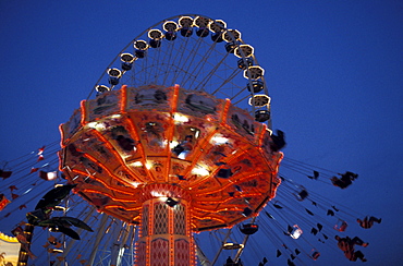 Illuminated fairground ride in the evening, Bad Cannstatt fair, Stuttgart, Baden Wuerttemberg, Germany, Europe