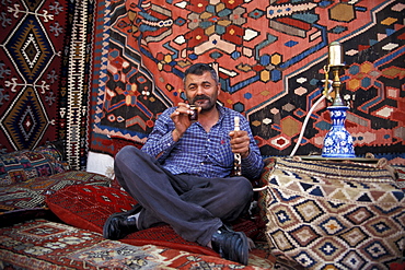 Carpet dealer smoking waterpipe, Antalya, Antalya, Turkey