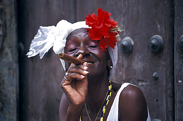 Mature woman smoking a cigar at the old town, Plaza de la Catedral, La Habana Vieja, Cuba, Caribbean, America