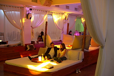 People sitting on a bed in a theme restaurant BED, South Beach, Miami, Florida, USA, America