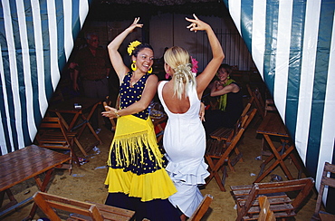 Women dancing at Feria del Vino Fino, Puerto de Santa Maria, Cadiz, Andalusia, Spain, Europe