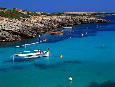 Boat in a bay, Cala de BinisafË™ller, Minorca, Balearic Islands, Spain