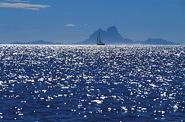 Sailing boat on glistening water, Bora Bora, French Polynesia