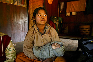 Mother sitting with baby on floor, Burma, Myanmar