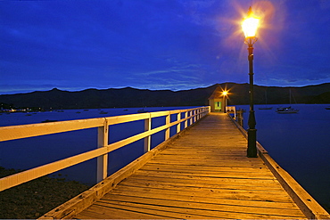 Jetty with lantern at harbour in the evening, Banks Peninsula, Akaroa, New Zealand, Oceania