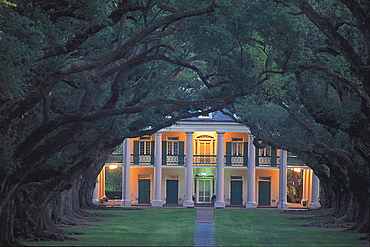 View through an oak alley at a house at dusk, Oak Alley Plantation, Lousiana USA, America