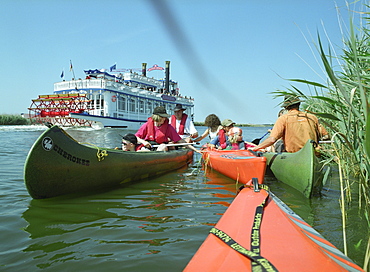Canoes and shuffle boat on Prerowstrom, Fischland-Darss-Zingst, Mecklenburg-Western Pomerania, Germany