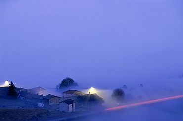 Village at Co du Fut d'Avenas in the fog, Beaujolais, France