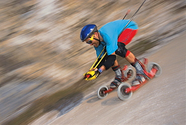 Man on mountainskates driving down a slope, Oesterreich, Austria, Europe