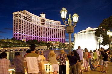 Tourists watching the famous Bellagio water show at the Bellagio Lagoon on Las Vegas Boulevard, Las Vegas, Nevada, USA