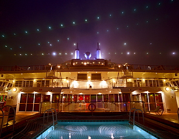 Illuminated deck and pool, Cruise ship Queen Mary 2