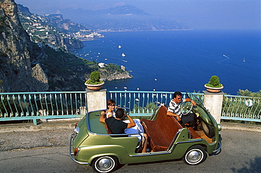 People in a vintage car at the coast in the sunlight, Amalficoast, Campania, Italy, Europe