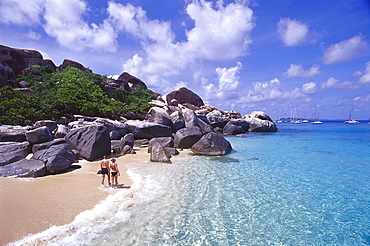 Couple strolling along a beach with rocks, The Baths, Virgin Gorda, British Virgin Islands, Caribbean, America