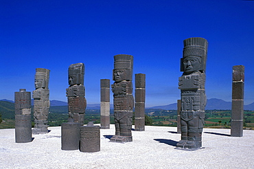 Sculptures under blue sky, Atlases on pyramid B, Tula, Hidalgo, Mexico, America