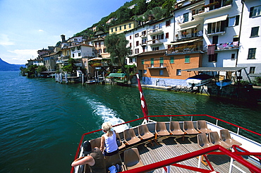 Gandria, People on excursion boat leaving Gandria, Lake of Lugano, Tessin, Switzerland