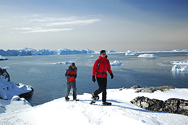 A couple snowshoeing, Ilulissat, Greenland