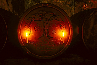 Old candle lit wine barrel at wine cellar of Castle Johannisberg, Rheingau, Hesse, Germany, Europe