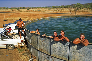 fun cooling off in bore water tank, Kimberley, West Australia, Australia