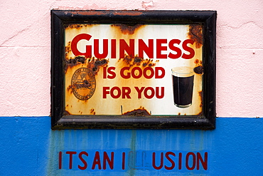 Old advertising sign for beer outside Dan Foley`s Pub in Annascaul, County Kerry, Ireland Europe