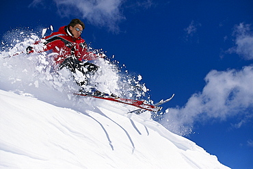 Freeskiing, skier on snowy mountainside in the sunlight