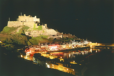 The illuminated Orgeuil Castle above the harbour of Gorey, Jersey, Channel Islands, United Kingdom