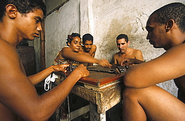 small group playing dominoes in heat of day, Cuba