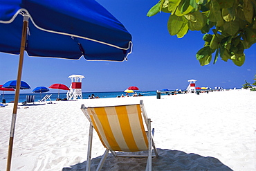 Deck chair standing at the beach in the sunlight, Doctors Cave, Montego Bay, Jamaica, Caribbean