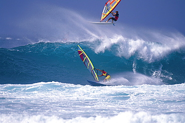 Two sailboarders in front of a wave, France, Europe