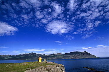 Coastal landscape and bay in the evening light, Faskrudsfjoerdur, Iceland